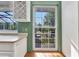 Kitchen window with an outside view, cabinet for glasses, and a great view of the back yard at 5601 Taylor Rd, Punta Gorda, FL 33950