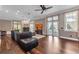 Spacious living room with fireplace, hardwood floors, and French doors to the pool at 5601 Taylor Rd, Punta Gorda, FL 33950