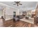 Cozy living room with a leather sofa, fireplace, hardwood floors, and elegant lighting at 5601 Taylor Rd, Punta Gorda, FL 33950