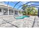 Beautiful screened-in pool area with a spacious paver patio at 5601 Taylor Rd, Punta Gorda, FL 33950