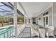 Covered outdoor porch with ample seating, a ceiling fan, and views of the pool at 5601 Taylor Rd, Punta Gorda, FL 33950