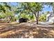 Spacious, covered storage area surrounded by mature trees, ideal for storing equipment or outdoor gear at 5601 Taylor Rd, Punta Gorda, FL 33950