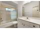 Clean bathroom with a vanity, toilet, and a shower-tub combination featuring a gold sliding door at 6938 Rabbit Ave, North Port, FL 34291