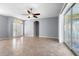 Spacious living room featuring neutral walls, large windows, and tile floors throughout at 6938 Rabbit Ave, North Port, FL 34291