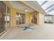 Covered patio featuring a decorative starfish rug and access to the screened pool area and house at 6938 Rabbit Ave, North Port, FL 34291