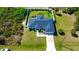 Expansive aerial view of a home with a fenced backyard, patio set, mature landscaping and well kept lawn at 7243 Patricia Pl, Englewood, FL 34224