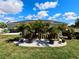 Well-maintained yard with landscaping surrounding home, accented by a decorative stone border at 7243 Patricia Pl, Englewood, FL 34224