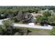 Aerial shot of home with long driveway surrounded by lush greenery and mature trees at 825 Robinhood Dr, Punta Gorda, FL 33982