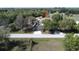 Single-Gathering house with a long drive in a lush area with mature trees at 825 Robinhood Dr, Punta Gorda, FL 33982