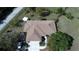 Single-story house with mature landscaping, two-car garage, and a large deck at 825 Robinhood Dr, Punta Gorda, FL 33982