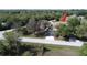 Expansive property with a long driveway leading to a charming home nestled among mature trees at 825 Robinhood Dr, Punta Gorda, FL 33982