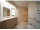 Well-lit bathroom with a toilet, handrails, and a vanity with ample counter space at 825 Robinhood Dr, Punta Gorda, FL 33982