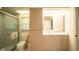 Well-lit bathroom featuring a shower, toilet, and vanity with built-in storage at 825 Robinhood Dr, Punta Gorda, FL 33982