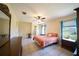 Comfortable bedroom featuring a ceiling fan and a large window at 825 Robinhood Dr, Punta Gorda, FL 33982