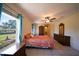 Comfortable bedroom featuring a ceiling fan and a large window at 825 Robinhood Dr, Punta Gorda, FL 33982