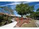 A cozy wooden deck area with seating, surrounded by lush landscaping and mature trees, perfect for outdoor relaxation at 825 Robinhood Dr, Punta Gorda, FL 33982