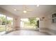 Enclosed lanai features tile flooring, a ceiling fan, and an open view of the backyard at 825 Robinhood Dr, Punta Gorda, FL 33982