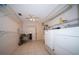 Spacious laundry room featuring tile floors, storage shelves, and modern washer and dryer at 825 Robinhood Dr, Punta Gorda, FL 33982