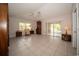 Inviting living room with tile floors and access to the lanai through sliding glass doors at 825 Robinhood Dr, Punta Gorda, FL 33982