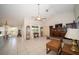 Spacious living room with tiled flooring, a ceiling fan, and ample natural light at 825 Robinhood Dr, Punta Gorda, FL 33982