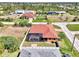 Aerial view showcasing this charming home with a pool, screened lanai, and well-maintained yard at 10393 Harlingen St, Port Charlotte, FL 33981