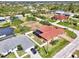 Aerial view of home with screened-in pool, fenced yard, and well-maintained landscaping at 10393 Harlingen St, Port Charlotte, FL 33981