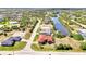 Aerial view of home showcasing its prime location on a canal with private dock and serene surroundings at 10393 Harlingen St, Port Charlotte, FL 33981