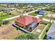 Aerial view featuring a beautiful waterfront home, with a well-manicured lawn at 10393 Harlingen St, Port Charlotte, FL 33981