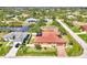 Overhead view of house with screened pool and waterway access in a tropical community at 10393 Harlingen St, Port Charlotte, FL 33981