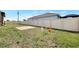 Large fenced backyard with grassy lawn, brick patio, and room for outdoor activities at 10393 Harlingen St, Port Charlotte, FL 33981