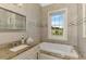 Bathroom features granite countertops and a large window overlooking the backyard offering ample light and space at 10393 Harlingen St, Port Charlotte, FL 33981