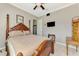 Bedroom with a four-poster bed and a wall-mounted television at 10393 Harlingen St, Port Charlotte, FL 33981