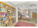 Bright bedroom with a canopy bed, a bookshelf and an ornate rug that adds warmth to the cozy space at 10393 Harlingen St, Port Charlotte, FL 33981