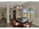 Elegant dining room features a dark wood table, six chairs, natural light and wood-look tile floors at 10393 Harlingen St, Port Charlotte, FL 33981