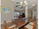 Formal dining room adjacent to the living area, with a large wooden table perfect for entertaining guests at 10393 Harlingen St, Port Charlotte, FL 33981
