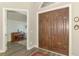 Inviting foyer with double wood doors, wood-look floors and a view to the living room at 10393 Harlingen St, Port Charlotte, FL 33981