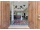 Inviting foyer with custom ceiling design leading into the living space with wood-look tile flooring at 10393 Harlingen St, Port Charlotte, FL 33981