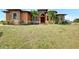 Stunning single-story home featuring lush lawn, front palms, and a warm, inviting entrance at 10393 Harlingen St, Port Charlotte, FL 33981