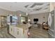 Open-concept kitchen with granite island and stainless steel appliances, connected to the living area at 10393 Harlingen St, Port Charlotte, FL 33981