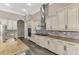 Modern kitchen with custom white cabinets, granite countertops, a large island and stainless steel appliances at 10393 Harlingen St, Port Charlotte, FL 33981