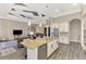 Open-concept kitchen with granite island and stainless steel appliances, flows into the living room at 10393 Harlingen St, Port Charlotte, FL 33981