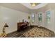 Elegant living room with a piano, large rug, and ample natural light at 10393 Harlingen St, Port Charlotte, FL 33981