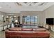 Open-concept living space with access to the lanai, features wood-look floors and a modern ceiling design at 10393 Harlingen St, Port Charlotte, FL 33981