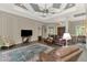 Elegant living room with custom ceiling design, wood-look floors, and classic furnishings at 10393 Harlingen St, Port Charlotte, FL 33981