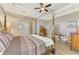 Serene main bedroom featuring a canopy bed, tray ceiling, and neutral decor at 10393 Harlingen St, Port Charlotte, FL 33981
