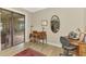 Cozy office space with a desk, chair, wood floors, and natural light from sliding glass door at 10393 Harlingen St, Port Charlotte, FL 33981