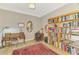 Traditional home office with an ornate wooden desk and bookcase filled with books for a classic, organized workspace at 10393 Harlingen St, Port Charlotte, FL 33981