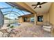Beautiful pool with a screened lanai, covered seating area, and lush landscaping at 10393 Harlingen St, Port Charlotte, FL 33981