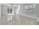 Bright living room with tile floors, a ceiling fan, and sliding glass doors leading to a deck at 1119 Ansin St, Punta Gorda, FL 33950