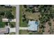 Aerial view of a home with a screened-in pool and a large yard at 1169 Presque Isle Dr, Port Charlotte, FL 33952